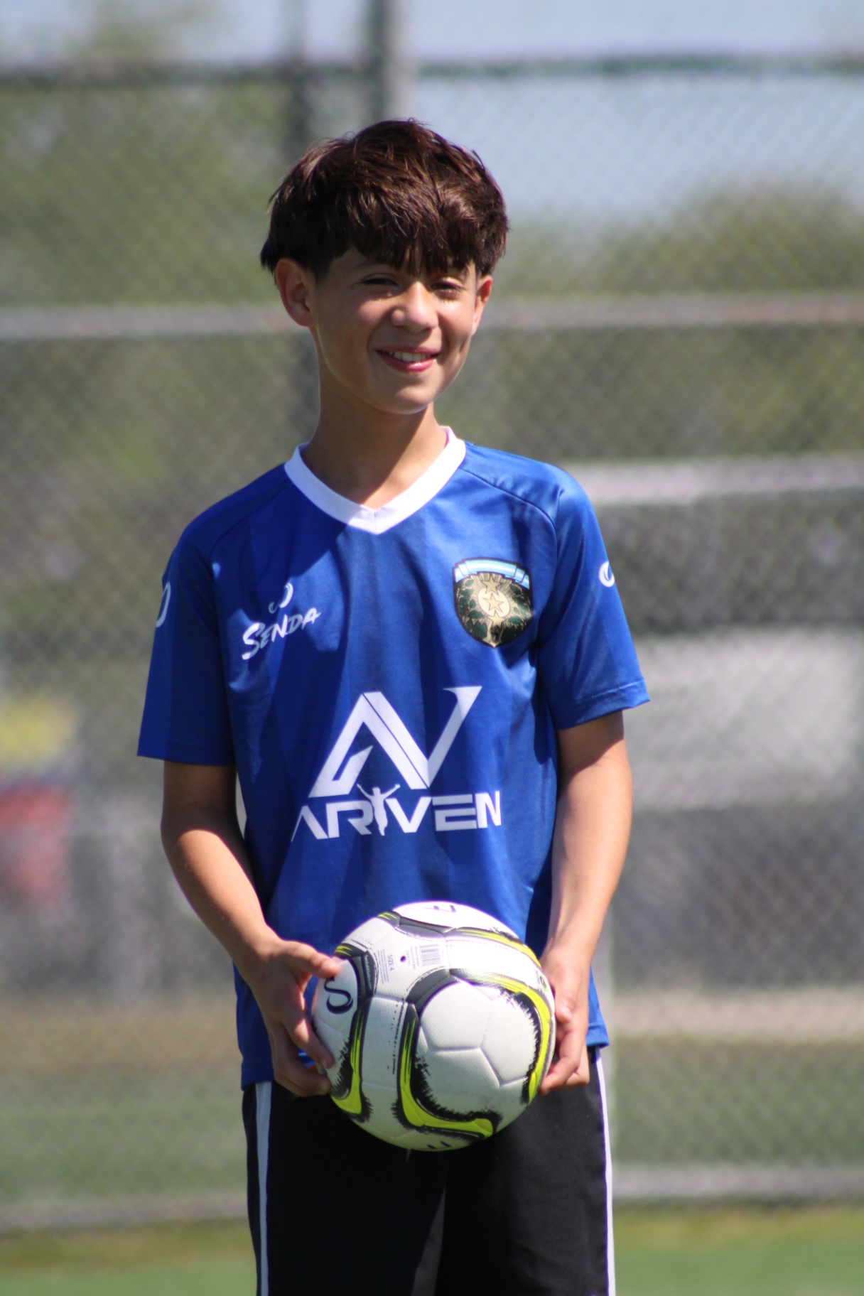 Smiling camp player holding a match ball