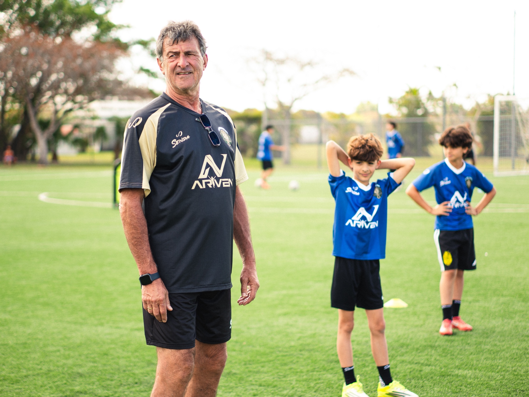 Mario Kempes on the field with young players at a Future Football Stars camp